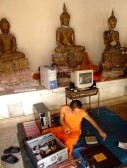 7492603-bangkok-thailand--april-03-thai-buddhist-monks-fix-a-computer-in-a-temple-in-charansanitwong-in-bang.jpg